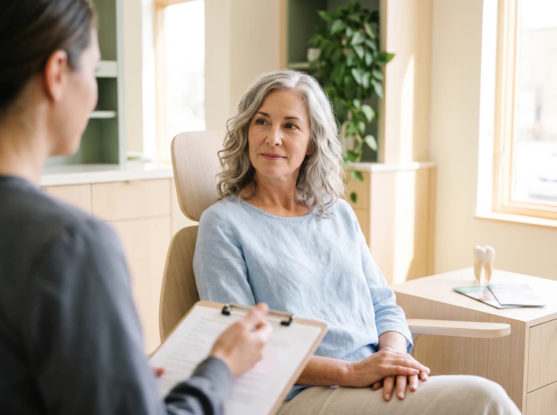 Illustrative portrait of an adult in a calm dental consultation room.