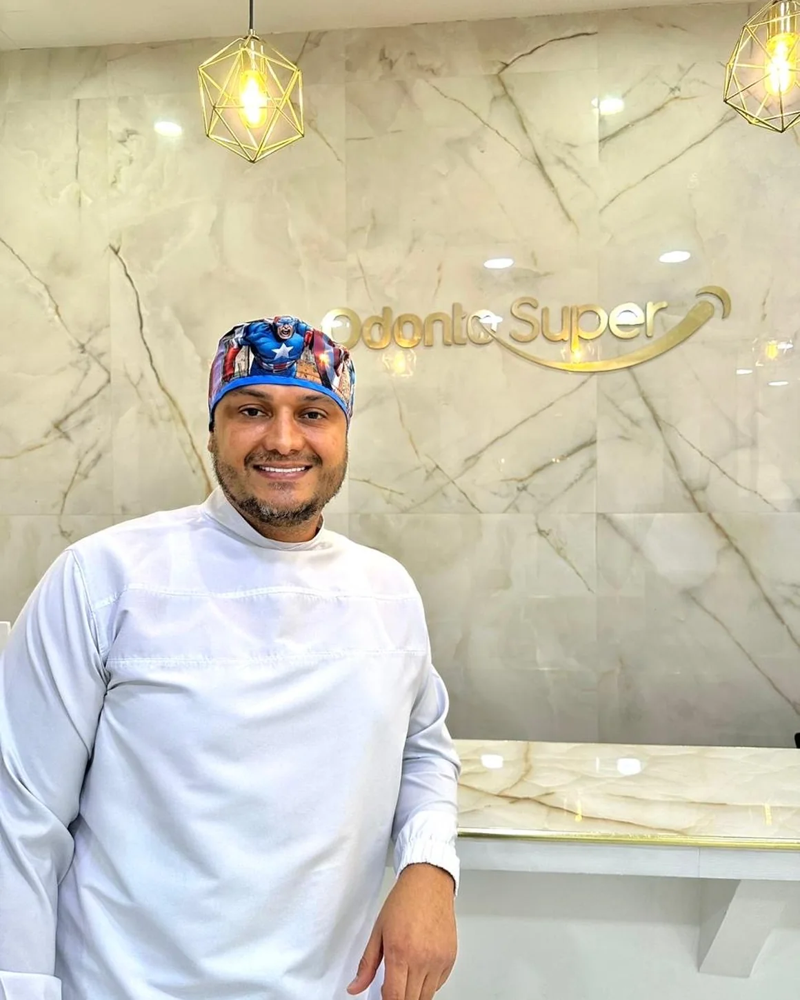 Clinician beside an Odonto Super wall sign