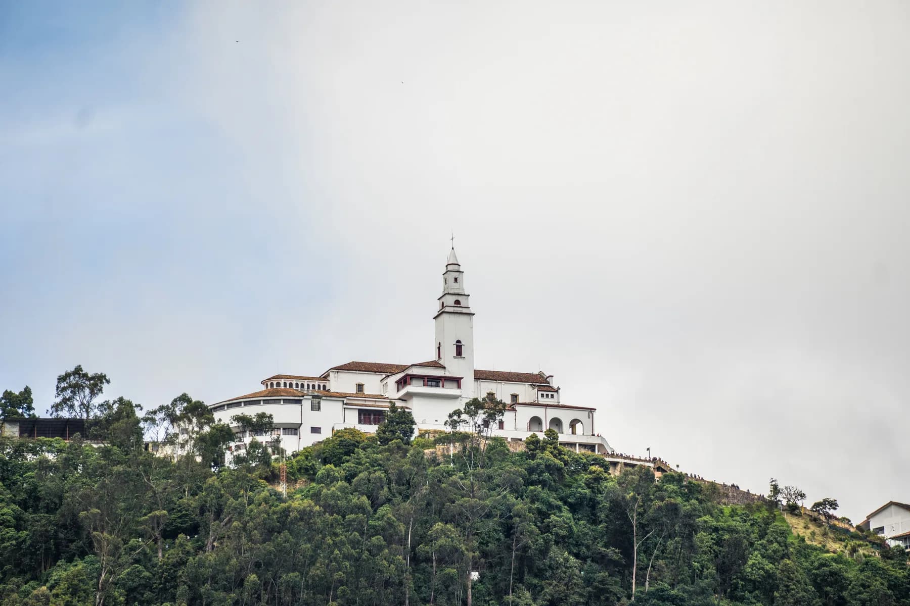 Monserrate Sanctuary rises above a wooded hillside in Bogotá, Colombia.