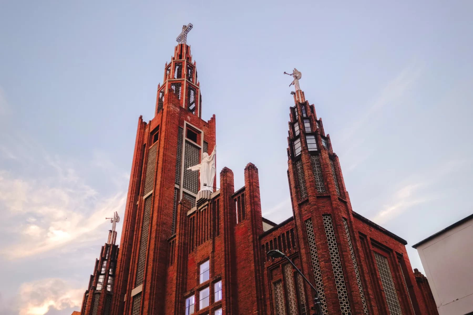The red-brick towers and white statue of Iglesia del Sagrado Corazón de Jesús in Bucaramanga, Colombia.