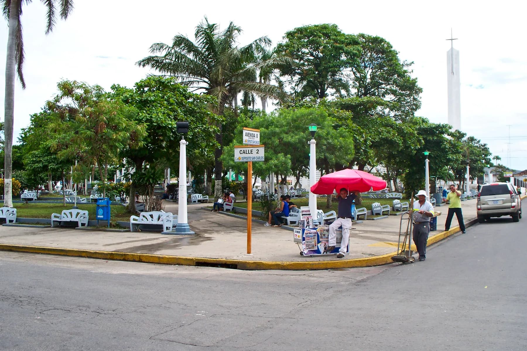 Liberia Central Park with shade trees, benches and street vendors in the city center.