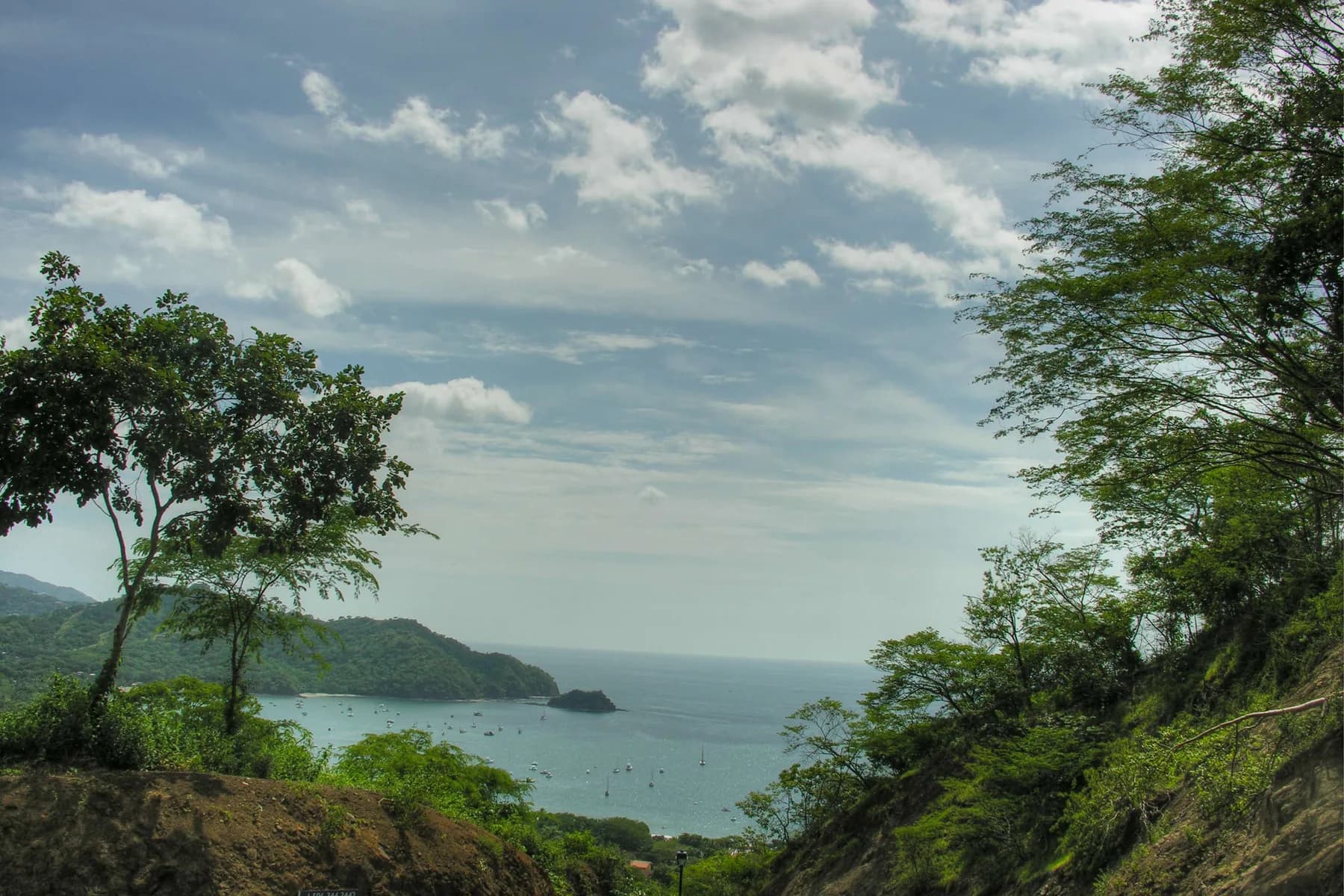 A hillside view over Playas del Coco bay, fishing boats and the Guanacaste headland.