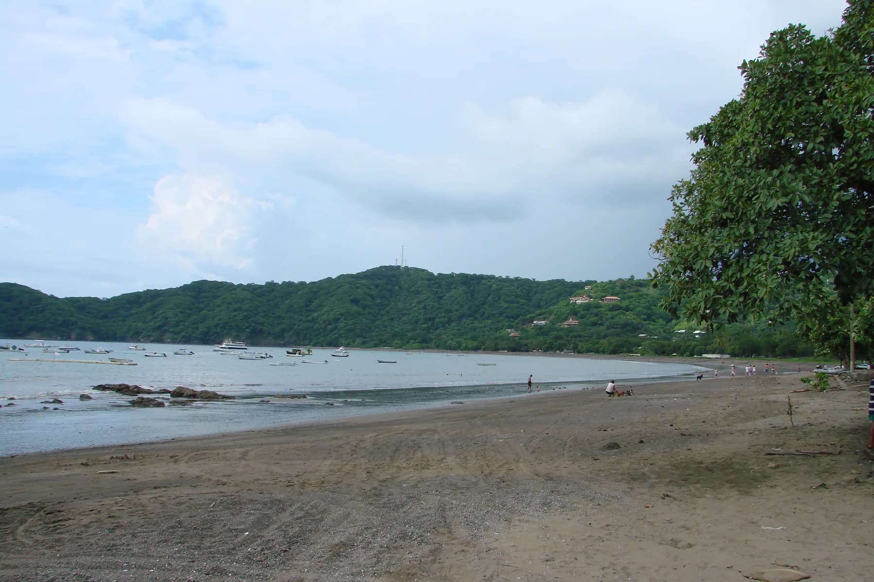 Fishing boats across Playas del Coco bay with its forested headland and beachfront in Guanacaste.