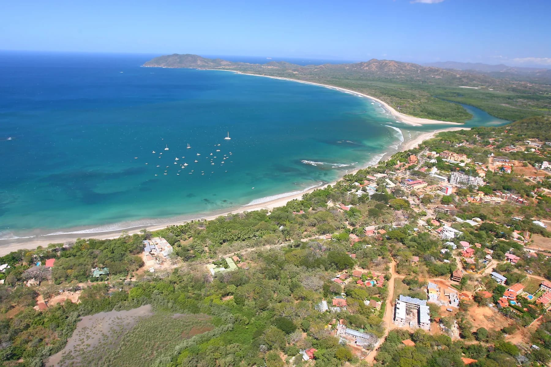 An aerial view of Tamarindo’s beachfront town, Playa Grande and the estuary on the Pacific coast.
