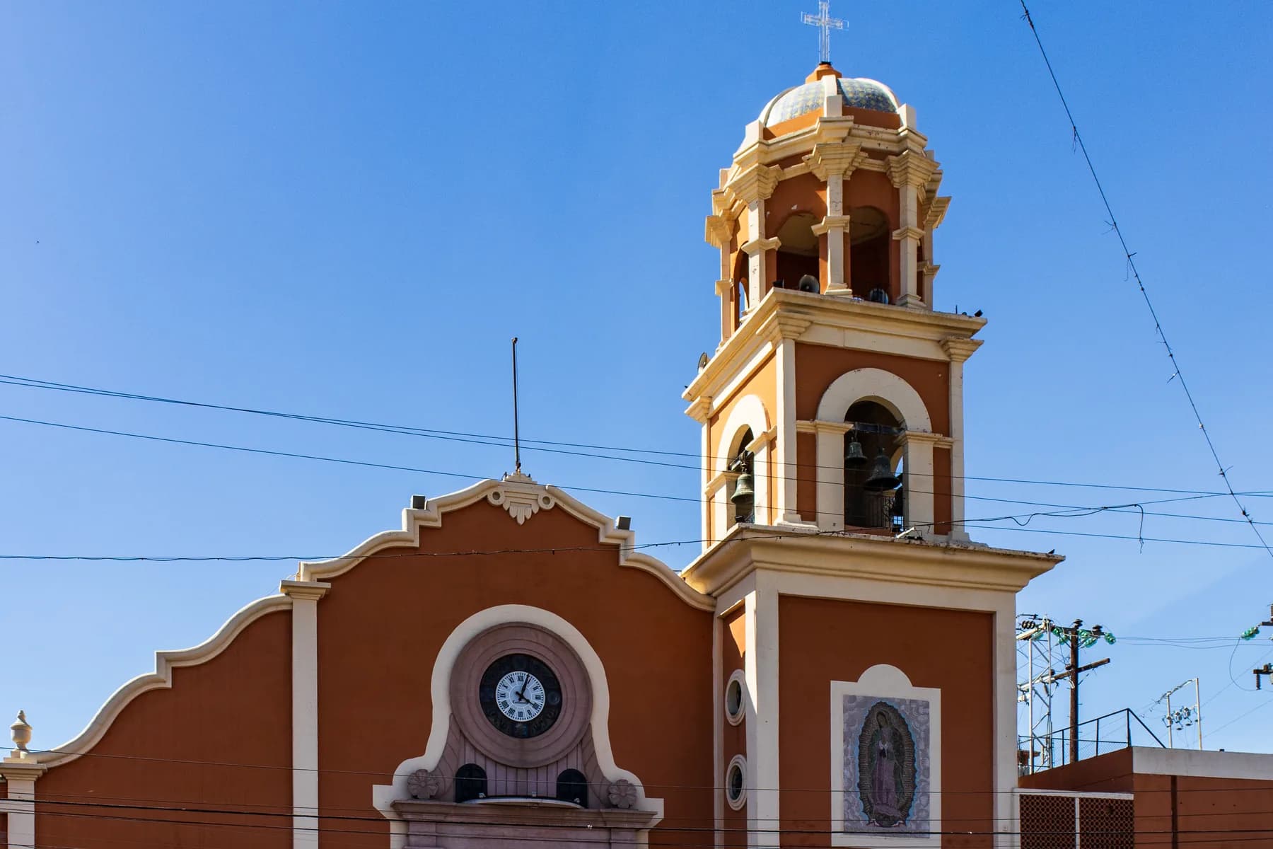 The Catedral de Nuestra Señora de Guadalupe bell tower and clock rise above central Mexicali, Mexico.