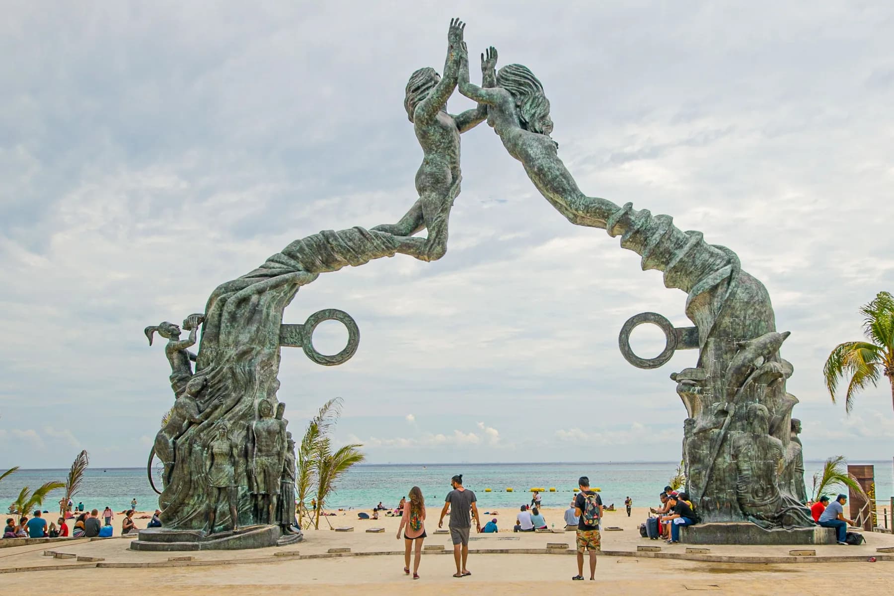 The Portal Maya sculpture frames the Caribbean shore at Parque Fundadores in Playa del Carmen, Mexico.