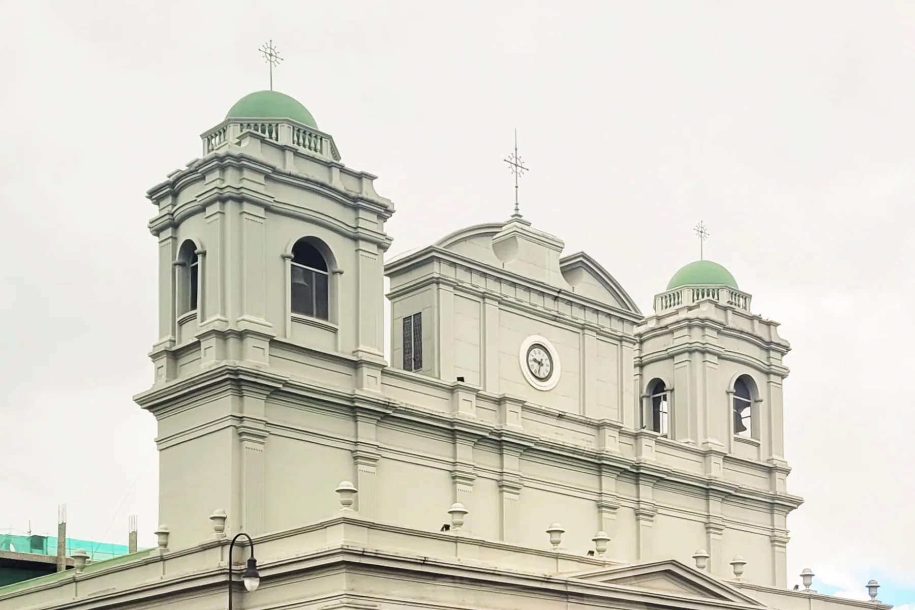 The Metropolitan Cathedral of San José, Costa Rica, with its twin green-domed towers and central clock.