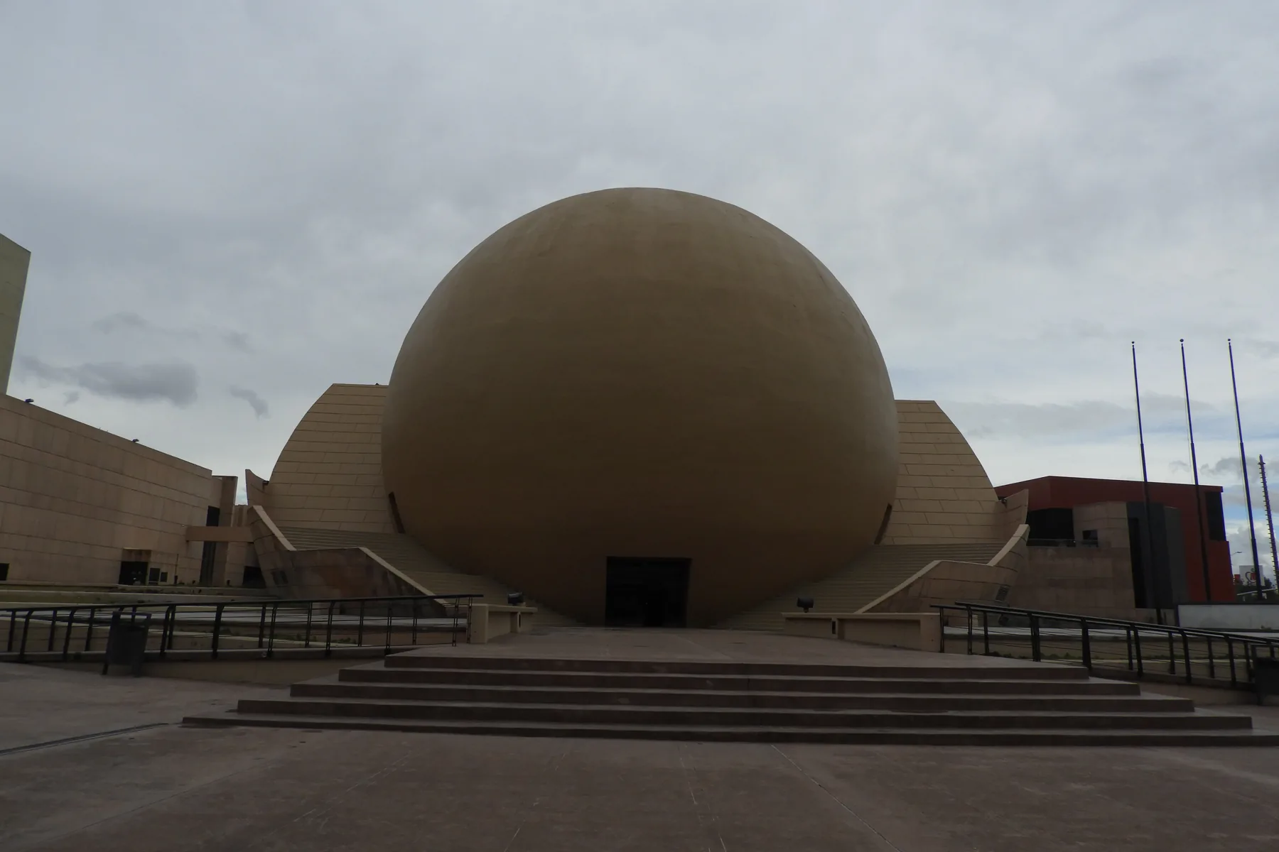 The spherical IMAX building at the Tijuana Cultural Center beneath a cloudy sky.