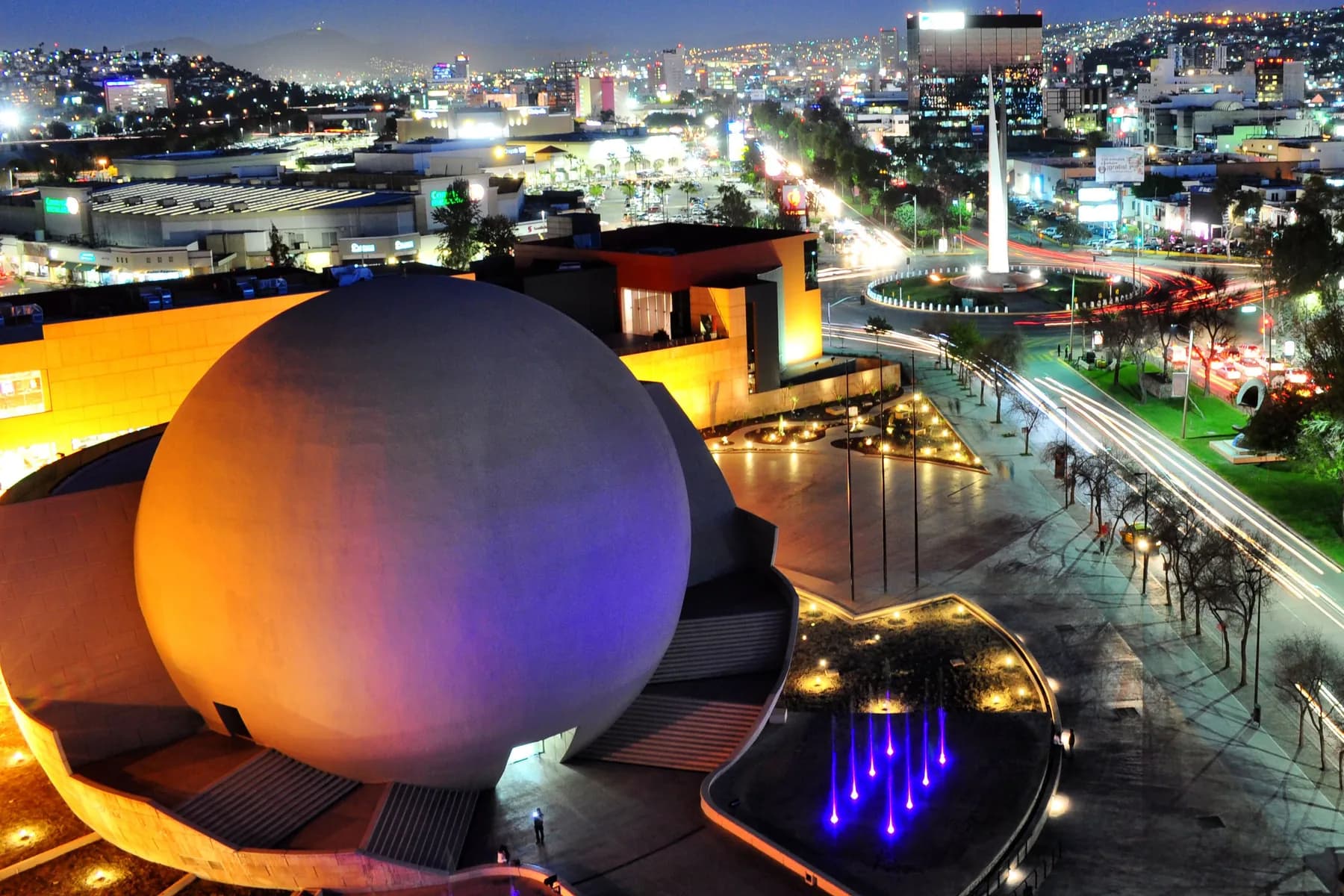 The Tijuana Cultural Center and Zona Rio illuminated beneath the city skyline at night.