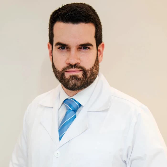 Sebastian Arias in a white clinical coat