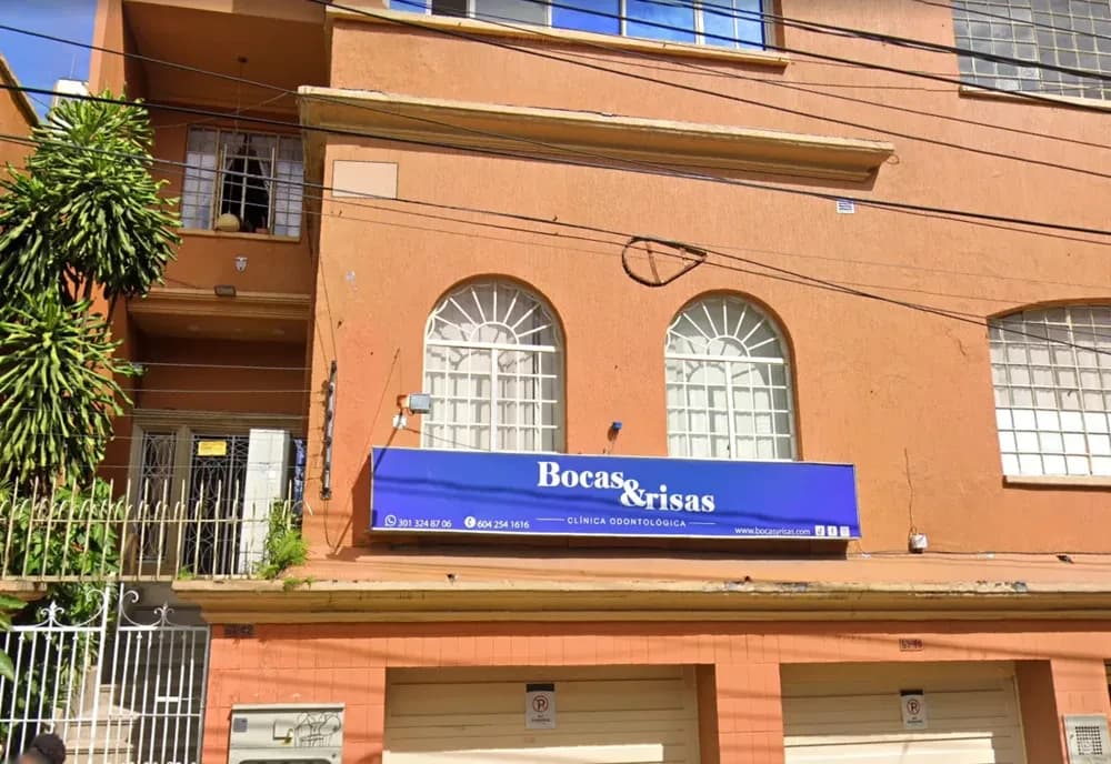 Street-facing orange building with Bocas y Risas clinic signage
