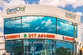 Dentioral clinic building with its name and contact details
