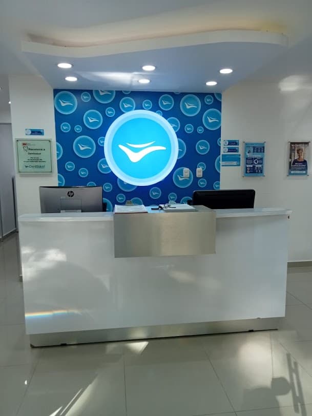 DentiSalud La Playa reception with blue clinic signage