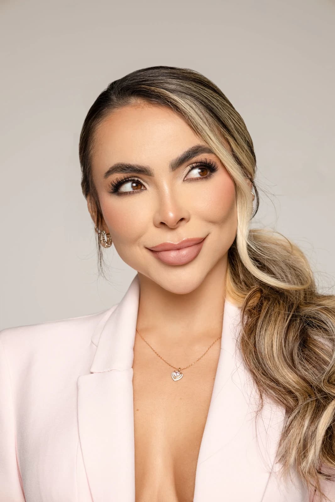 Carolina Bermudez in a pale pink jacket against a neutral background