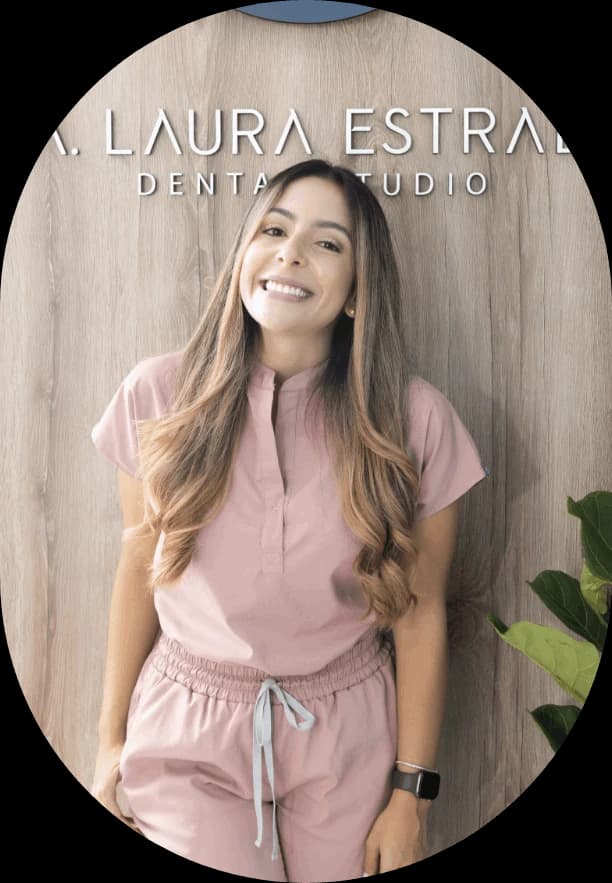 Laura Estrada in pink clinical clothing before LET Dental Studio signage