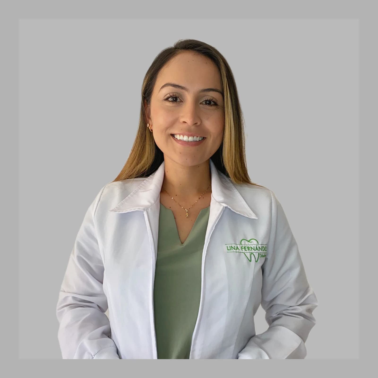 Lina Fernandez wearing a white clinical coat with practice embroidery
